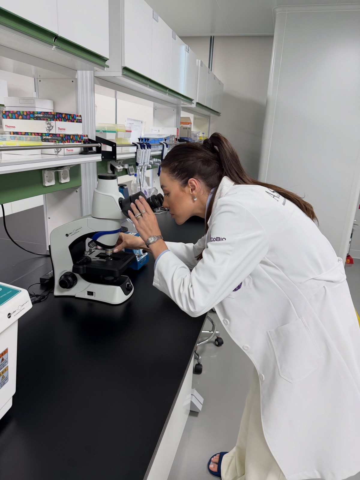 Brenda at a microscope in the ExoCoBio laboratory
